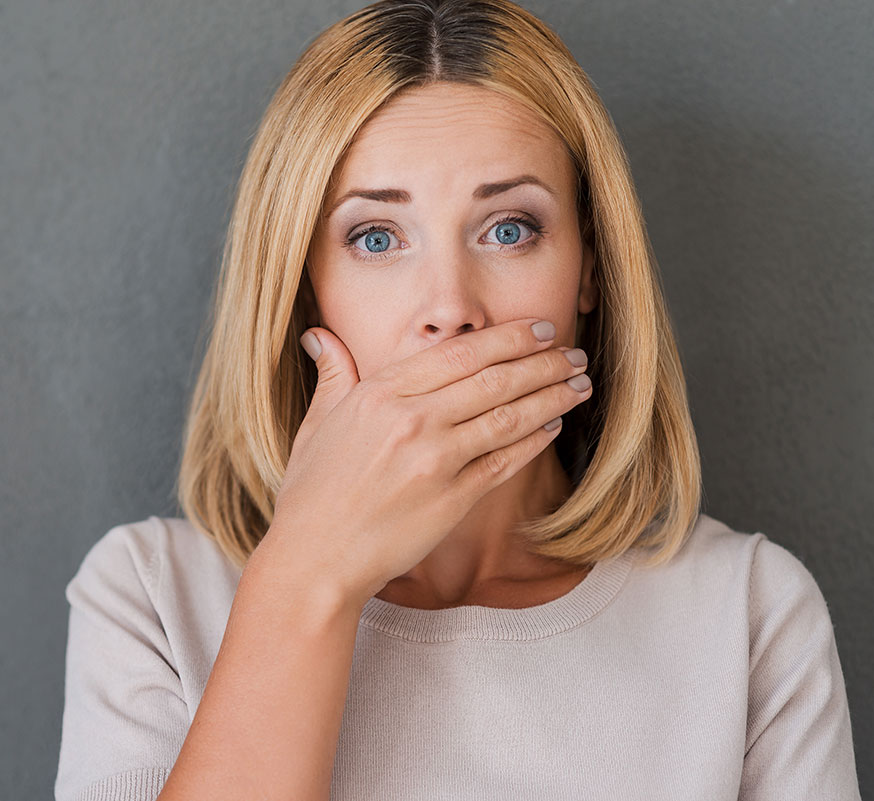 woman with hand hiding her mouth
