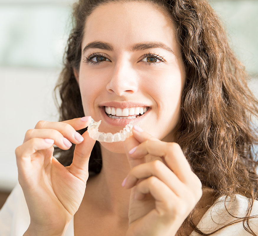 woman holding clear removable brace